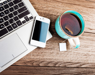 Office workplace with open laptop on wooden desk