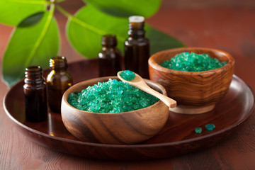 green herbal salt and essential oils for healthy spa bath