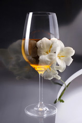 Double exposure of glass of wine over white freesia