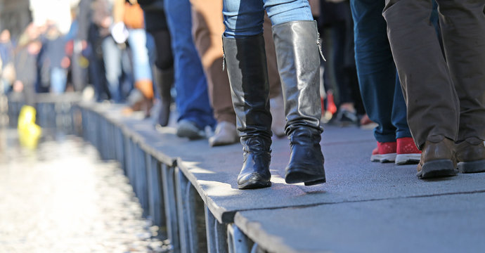 People Walking on the catwalk In Venice Italy