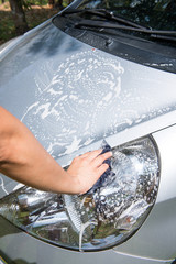 hand holding fabric for car washing