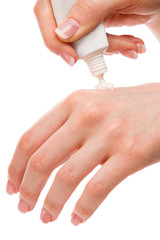 Woman applying moisturizer cream on hands