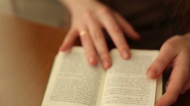 Women's hands leafing through a book + Slow-mo (HD)