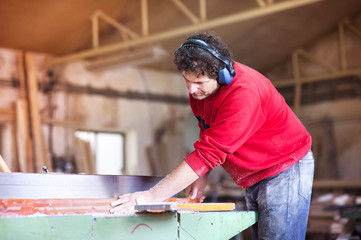 Carpenter working with wood planer