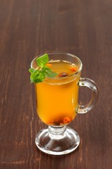 Sea-buckthorn tea with mint in glass mug