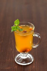 Sea-buckthorn tea with mint in glass mug