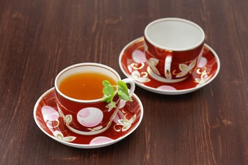 Sea-buckthorn tea with mint in red cups