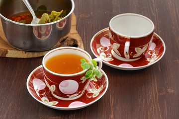 Sea-buckthorn tea with mint in red cups