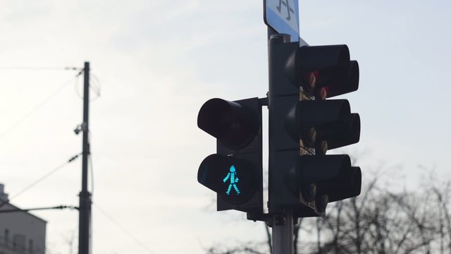 Pedestrian lights changing from green to red.