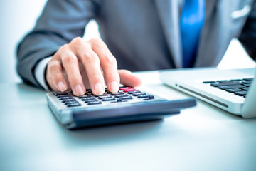 Closeup of businessman hands typing on laptop computer