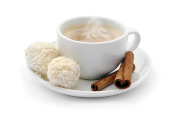 cup of coffee with chocolate candies and cinnamon