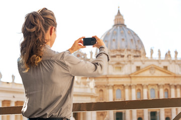 Woman taking photo of basilica di san pietro in Vatican city