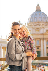Fototapeta premium Mother and baby girl on piazza san pietro in Vatican