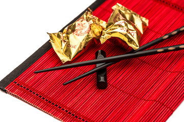 Fortune cookies and black chopsticks. Chinese new year decoratio