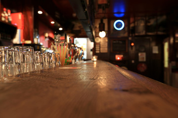 Bar, old wooden rack with glasses in the pub - obrazy, fototapety, plakaty