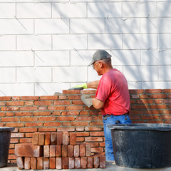 mason is bricklaying