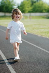 Fototapeta premium cute girl running at stadium photo