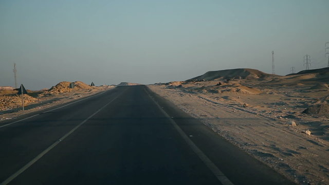Driving on a deserted road in sunset
