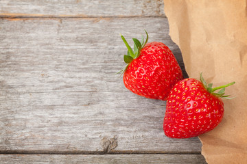Ripe strawberries over wooden table background