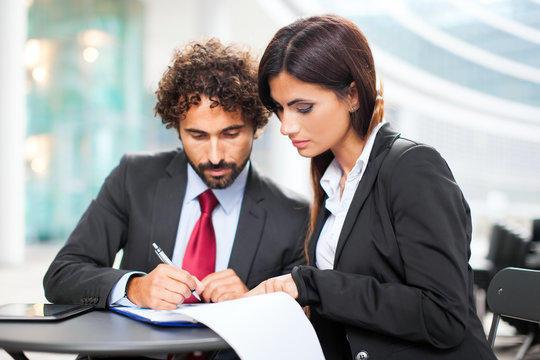 Business people signing a contract