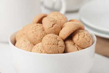 Amaretti Biscuits. Kitchenware. White Wooden Table