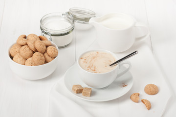 Amaretti Biscuits. Cup Of Cappuccino Coffee. Lump Demerara Sugar