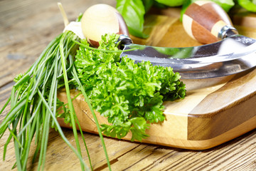 fresh and chopped herbs on cutting board