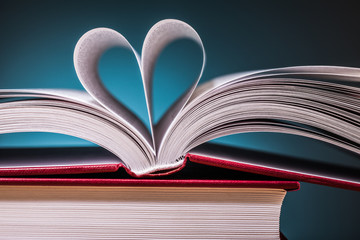 pile of books  and magnifying glass on wooden table