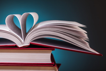 pile of books  and magnifying glass on wooden table