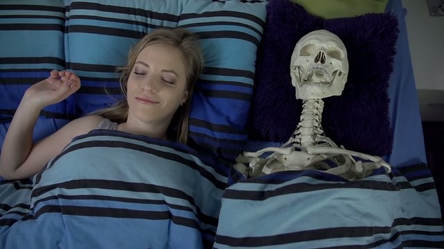 Woman is happy to wake up next to skeleton