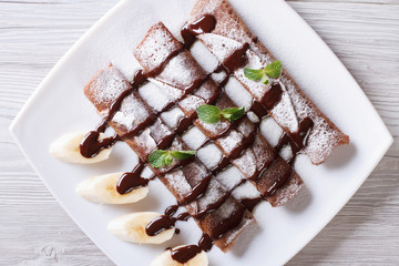 chocolate pancakes with sauce close-up horizontal top view