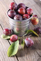 group of fresh plums on wood background