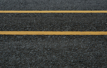 Fototapeta premium Asphalt texture with yellow lines