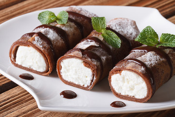 chocolate crepes with cream cheese close-up horizontal
