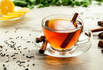 Glass cup of tea on a wooden table.