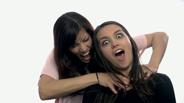 One women trying to strangle another on white background