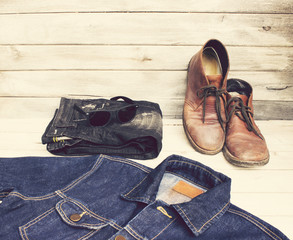 Vintage Style Clothing Shirts,shoes,sunglasses and jean on wood