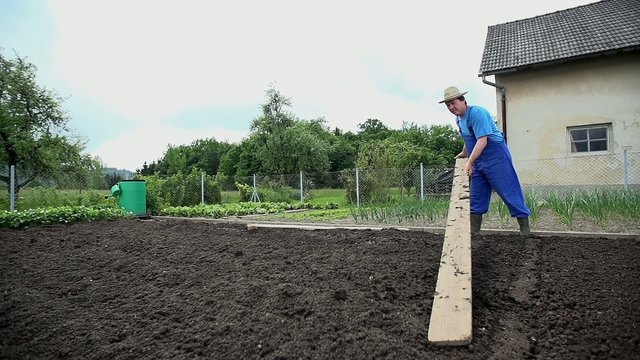 Grower moves large wooden boad to other part of garden