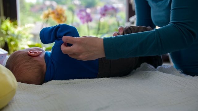 Dressing up a crying baby