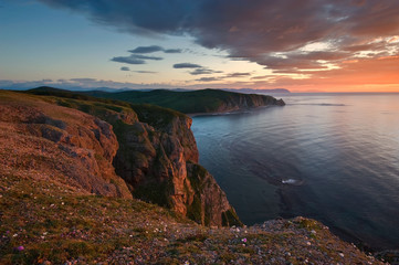 Fototapeta na wymiar Bright sunrise over the coast of the East Sea.