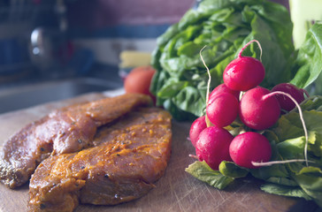 Raw seasoned pork meat on cutting board in the kitchen