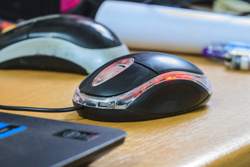 Computer mouse and laptop in background