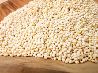 Quinoa seeds on a wooden bowl