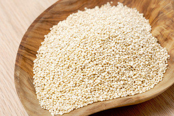 Quinoa seeds on a wooden bowl