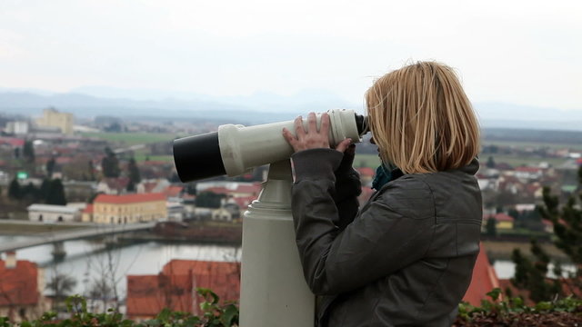 Shot of a woman looking thorugh binoculars