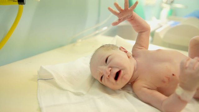 Nurse put just-born baby on a table