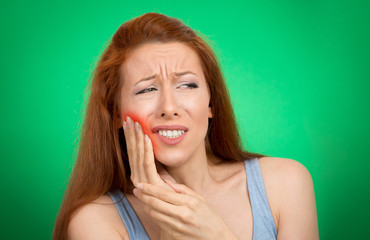 woman with sensitive tooth ache crown problem green background