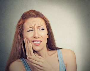 woman with sensitive tooth ache crown problem grey background 