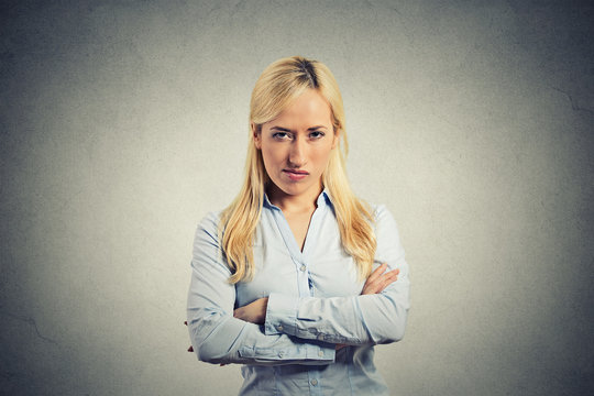 portrait angry blonde woman on grey wall background