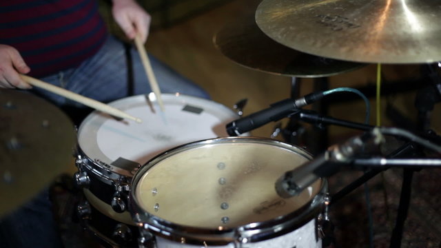 close up shot of musican playing drums